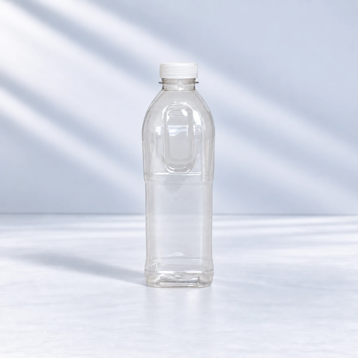 Clear 1 litre PET oil bottle with a white screw cap