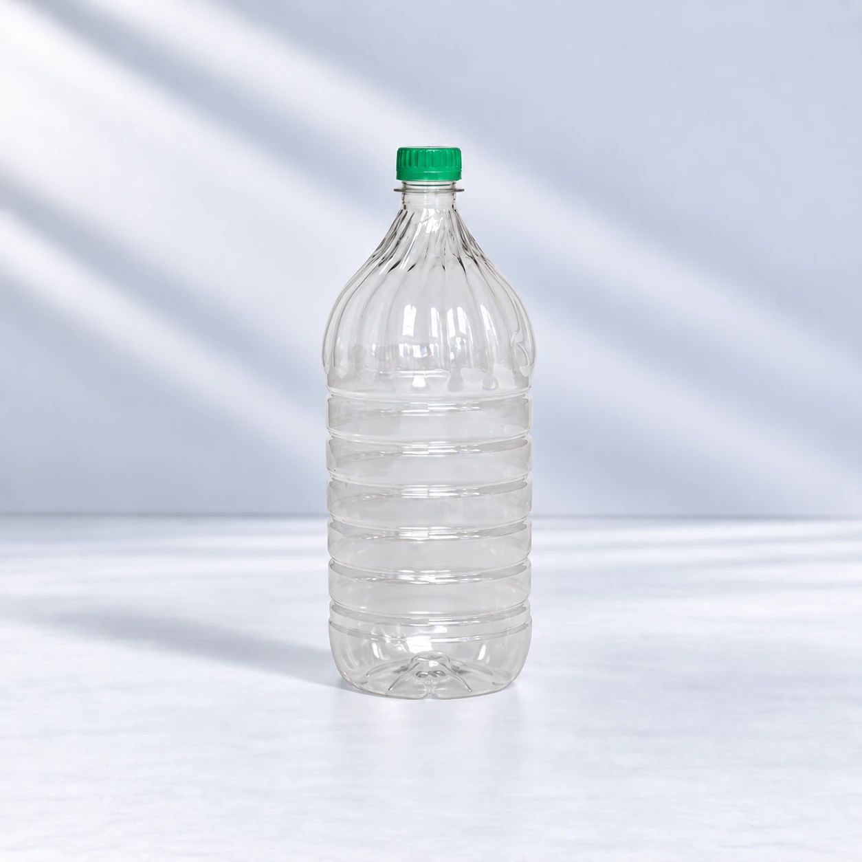 Clear standard 2 litre PET bottle with a ribbed body and green screw cap